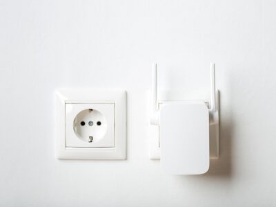 white wi-fi repeater indoors at home in outlet. wireless router.