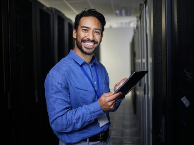 Tablet, man and portrait in server room of engineer programming at night. Information technology, f