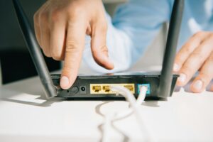 cropped view of businessman switching on router