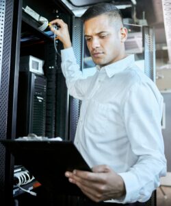 Server room, database and IT support with a man programmer working on an information storage soluti